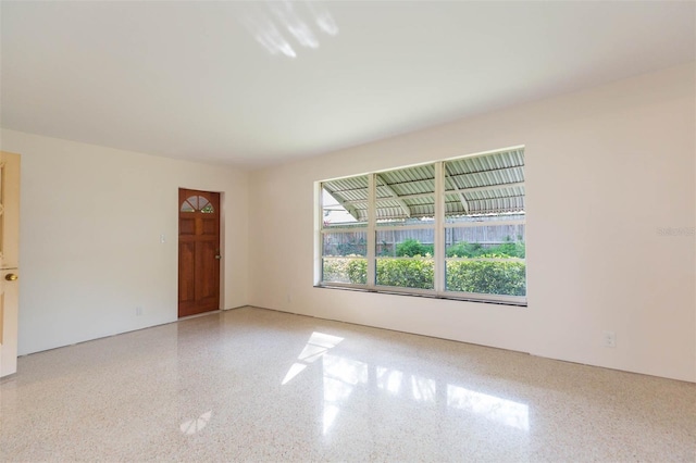 spare room with speckled floor