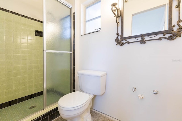 full bathroom featuring a stall shower and toilet