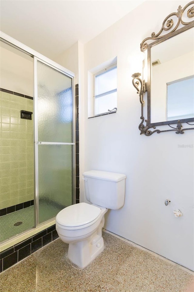 full bath with visible vents, speckled floor, a shower stall, and toilet