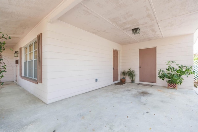 view of exterior entry featuring a patio area