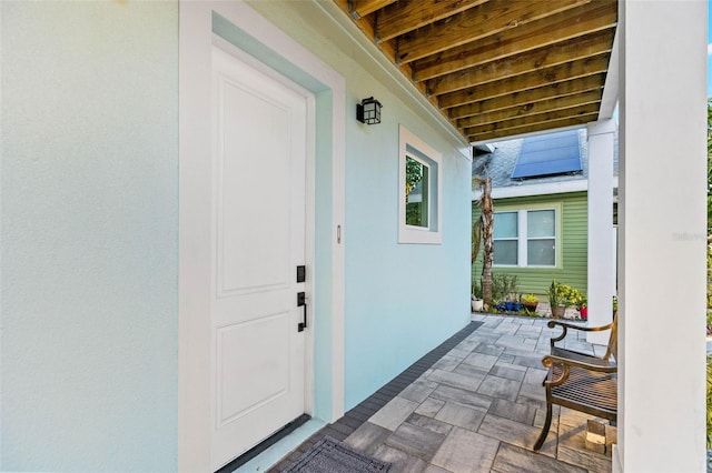 property entrance with stucco siding