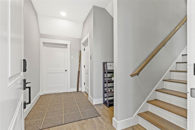 entrance foyer with stairway, recessed lighting, wood finished floors, and baseboards