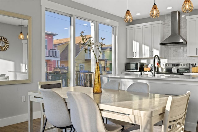 dining area with recessed lighting, wood finished floors, and baseboards