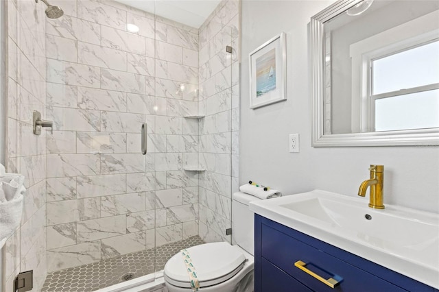 full bathroom with vanity, a shower stall, and toilet