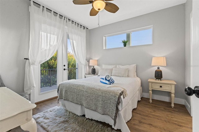 bedroom with baseboards, wood finished floors, a ceiling fan, and access to exterior