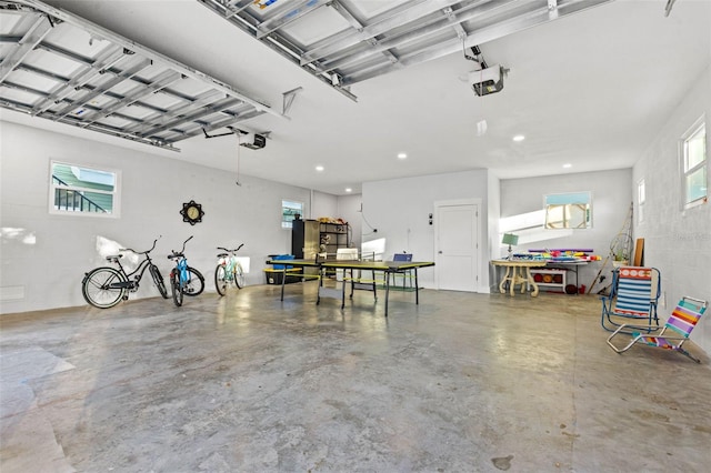 garage with recessed lighting and a garage door opener