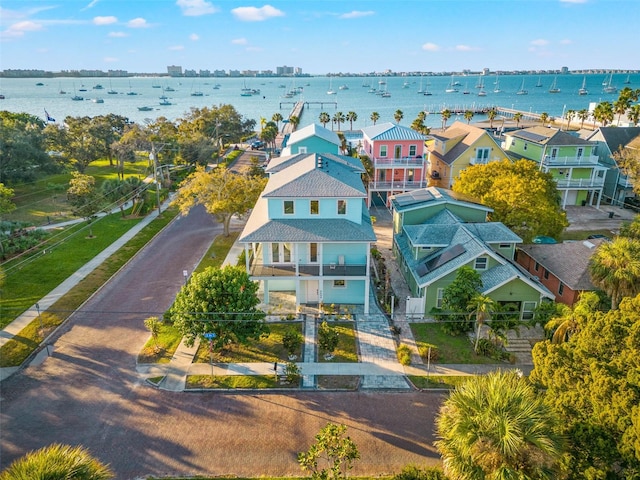 drone / aerial view featuring a water view and a residential view