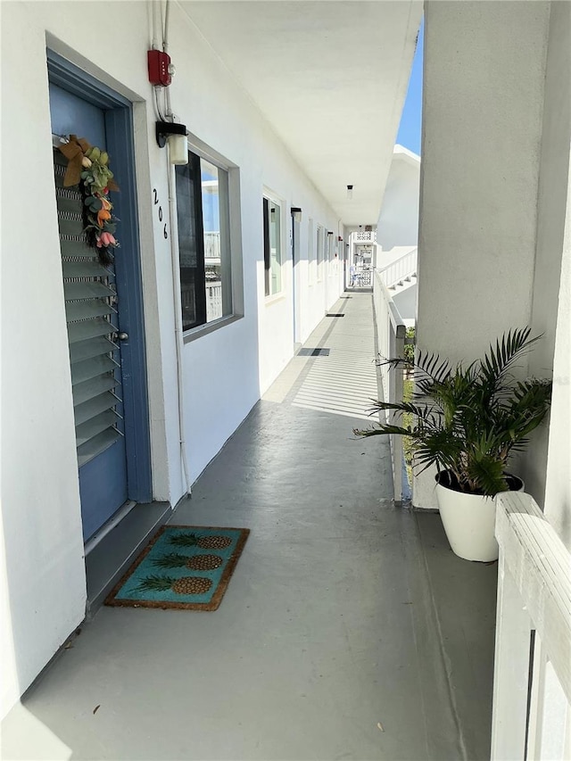 exterior space with a balcony and stucco siding