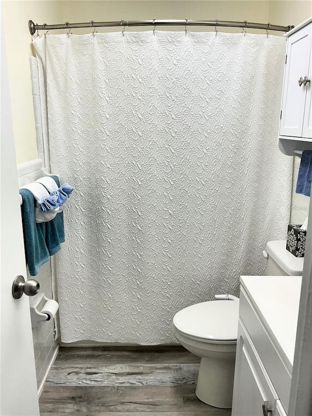 full bathroom with vanity, toilet, and wood finished floors