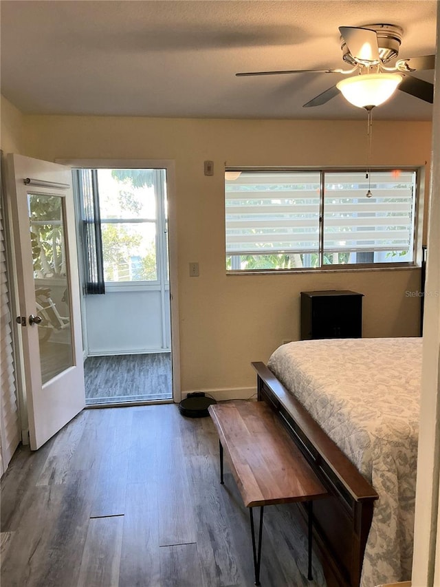 bedroom with wood finished floors, baseboards, and ceiling fan