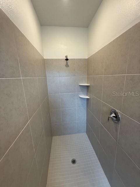 bathroom with a tile shower