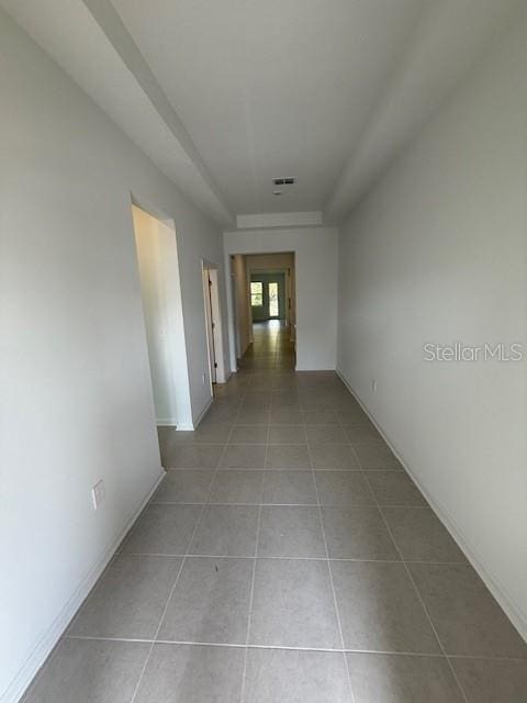 hall featuring french doors, visible vents, baseboards, and light tile patterned floors