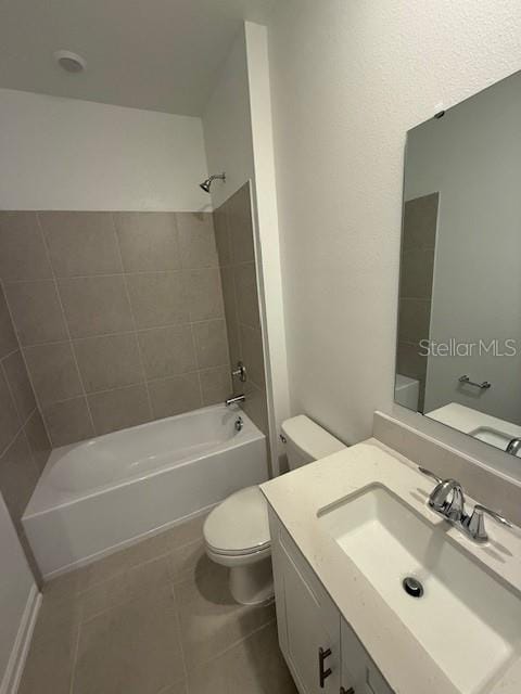 bathroom featuring vanity, bathing tub / shower combination, tile patterned flooring, and toilet