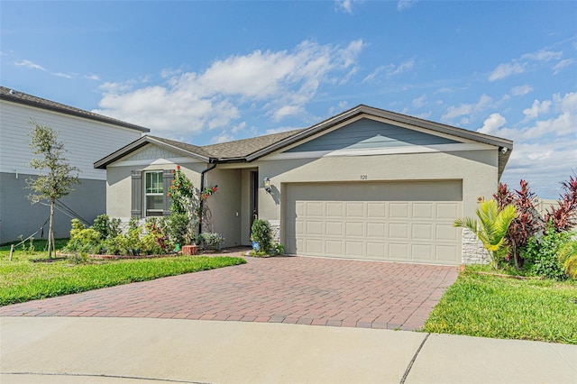 ranch-style house featuring decorative driveway, an attached garage, and stucco siding