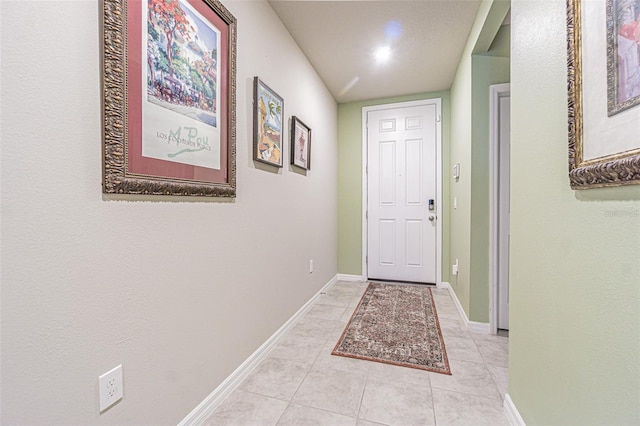 interior space featuring light tile patterned floors and baseboards