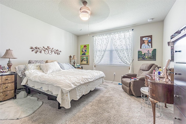 carpeted bedroom with a textured ceiling and ceiling fan