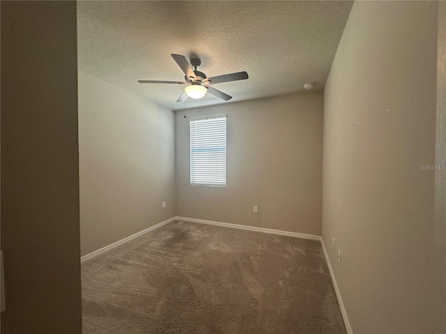 carpeted spare room featuring a ceiling fan, baseboards, and a textured ceiling