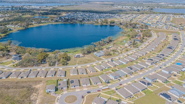 drone / aerial view featuring a residential view and a water view