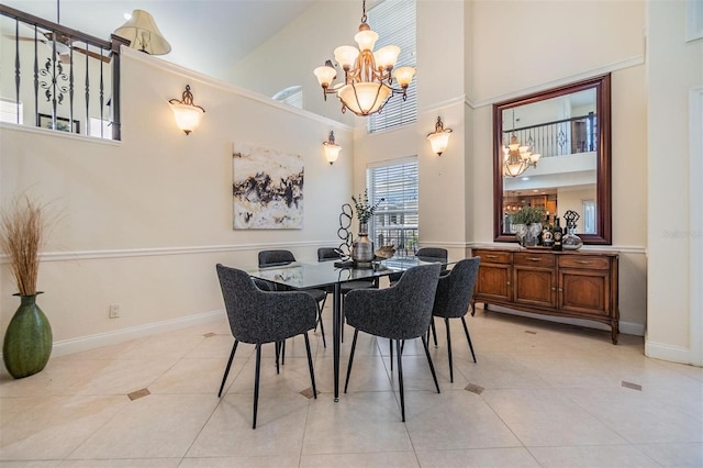 dining space with baseboards, light tile patterned flooring, a notable chandelier, and a high ceiling