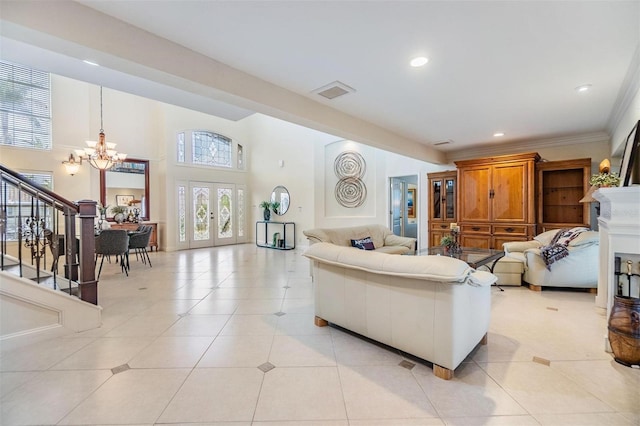 living area featuring light tile patterned floors, a notable chandelier, visible vents, stairs, and french doors