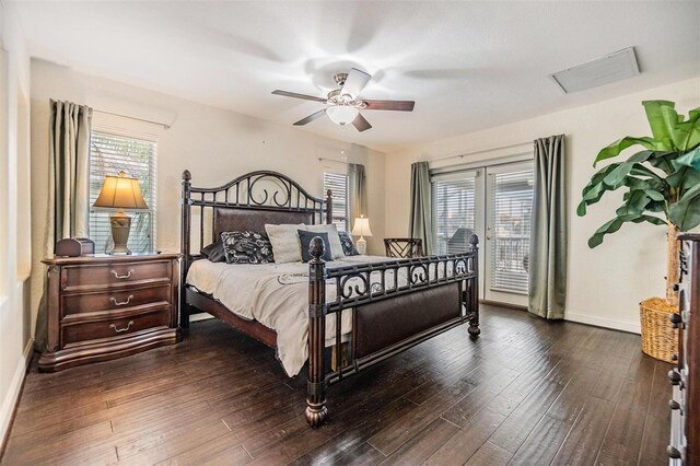 bedroom featuring access to exterior, dark wood-style flooring, multiple windows, and baseboards