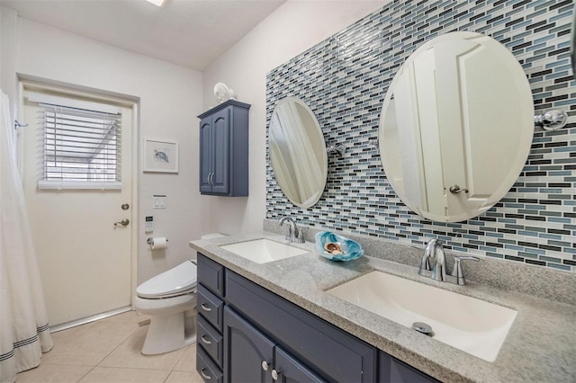 bathroom with tile patterned flooring, a sink, toilet, and decorative backsplash