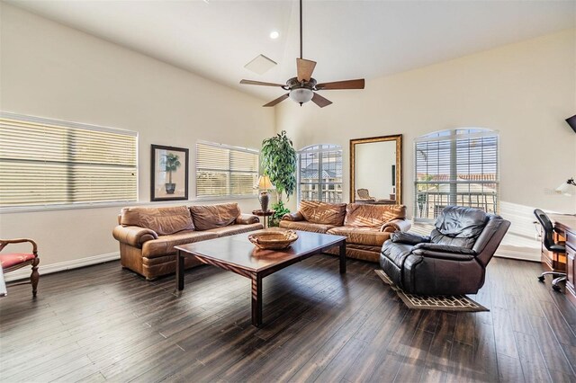 living room featuring a ceiling fan, dark wood-style flooring, and a wealth of natural light