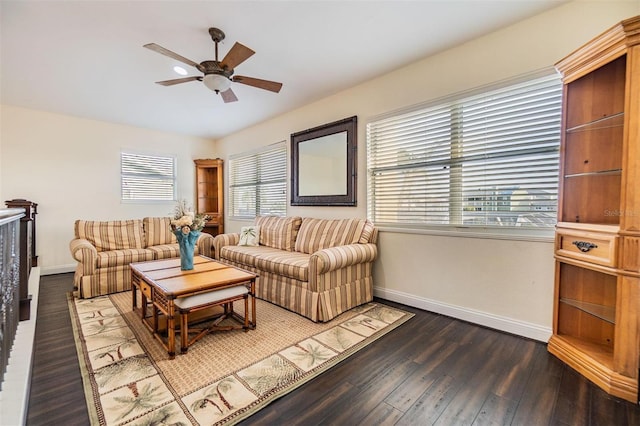 living room featuring dark wood-style floors, baseboards, and a ceiling fan