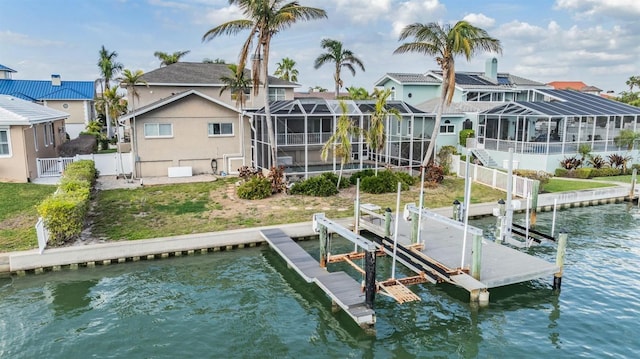 dock area featuring a water view, boat lift, a residential view, and a lanai