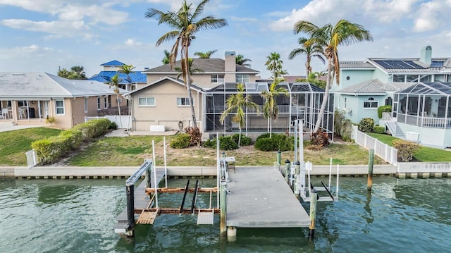 dock area featuring glass enclosure, a water view, boat lift, and a residential view