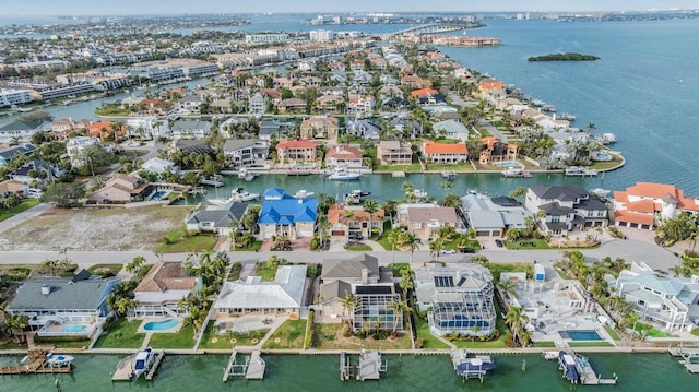 drone / aerial view featuring a water view and a residential view