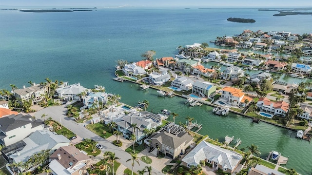 drone / aerial view featuring a water view and a residential view