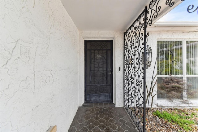 entrance to property with stucco siding