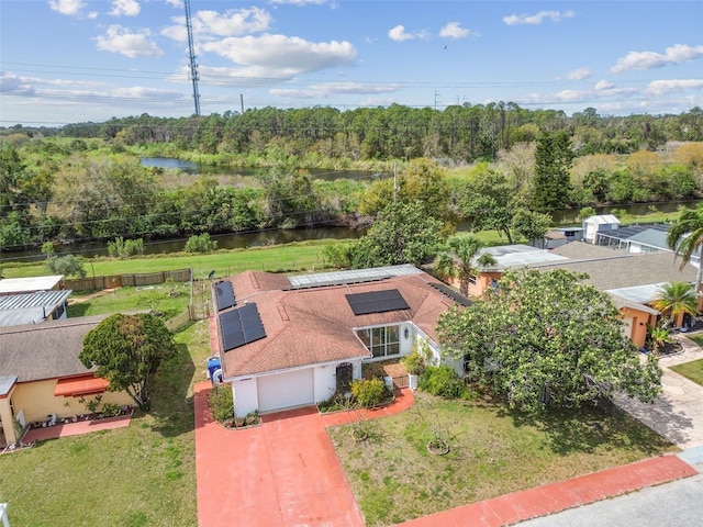 aerial view with a water view and a wooded view