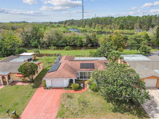 aerial view featuring a water view and a wooded view