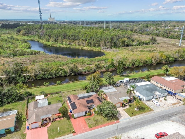 birds eye view of property with a water view and a view of trees