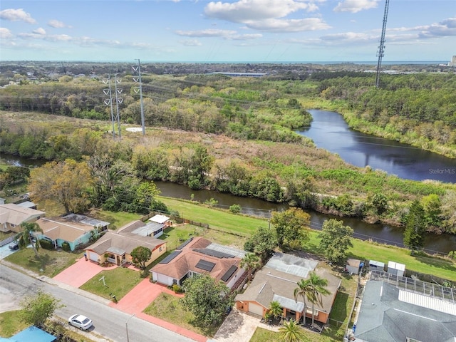 drone / aerial view with a water view and a wooded view