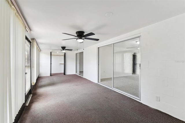 unfurnished bedroom featuring a ceiling fan, a closet, and carpet flooring