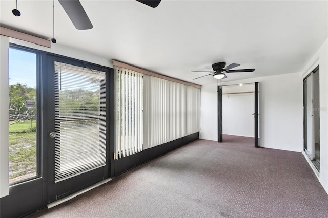 unfurnished sunroom featuring a ceiling fan