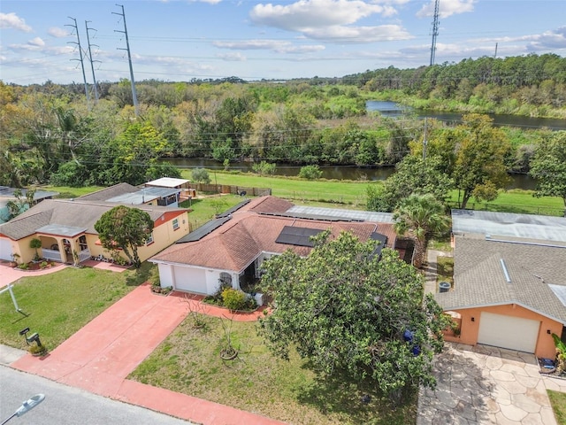 drone / aerial view featuring a wooded view