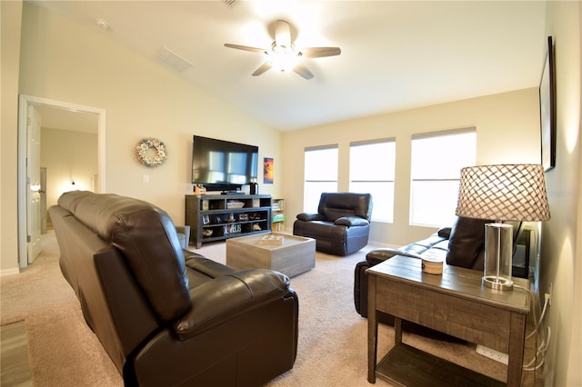 living room with visible vents, baseboards, a ceiling fan, light colored carpet, and lofted ceiling