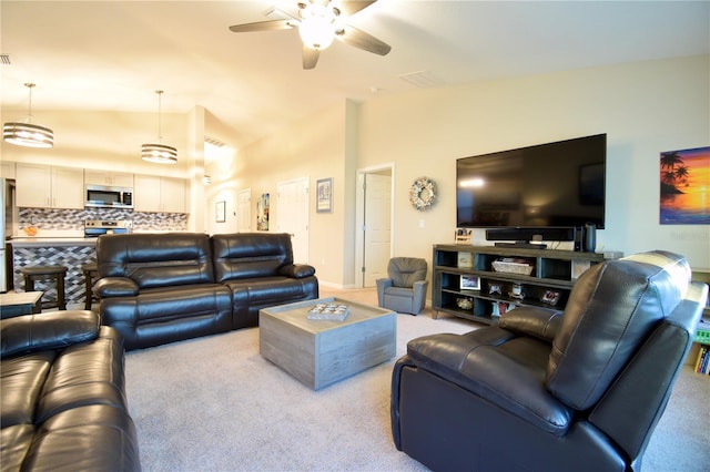 living room featuring lofted ceiling, carpet floors, and a ceiling fan