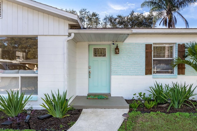 property entrance featuring concrete block siding