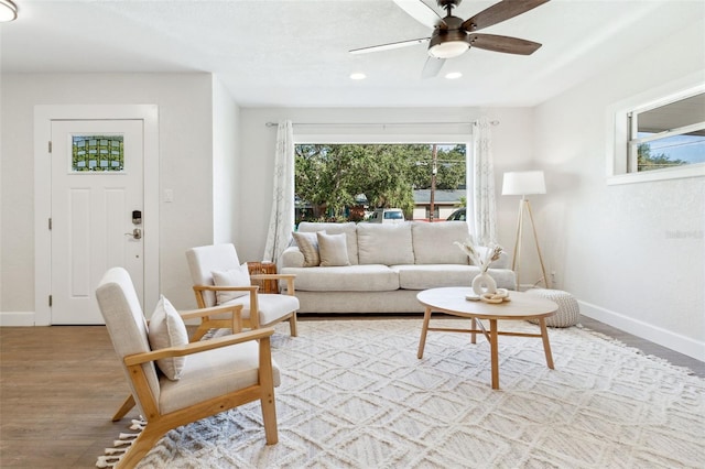 living area with ceiling fan, recessed lighting, wood finished floors, and baseboards