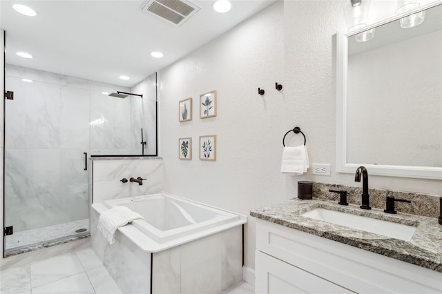 bathroom featuring a bath, vanity, a marble finish shower, and visible vents