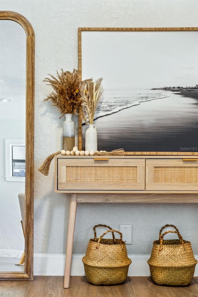 interior details with a textured wall and wood finished floors