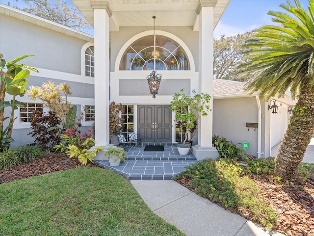 property entrance with stucco siding