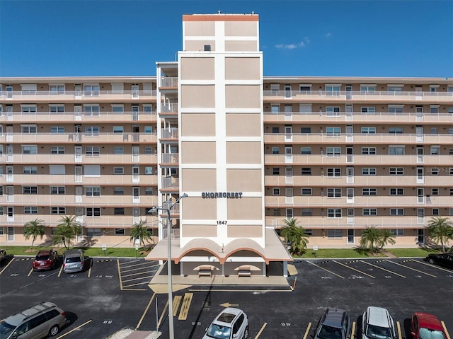 view of building exterior featuring uncovered parking