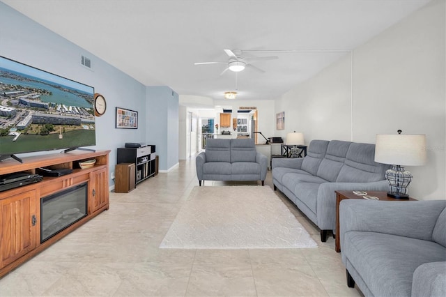 living area featuring a ceiling fan and visible vents