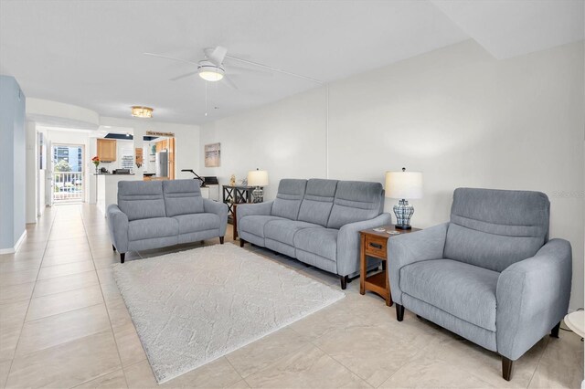 living area featuring light tile patterned floors and a ceiling fan